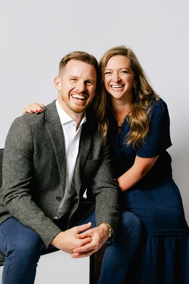Ashley and Calum Gordon laughing together in the studio; partners in Blueprinted Collective.